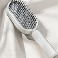 Escova de cabelo autolimpante com botão retrátil